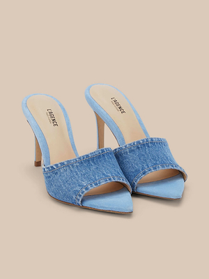 The Lolita Denim Open-Toe Mule features light blue denim uppers, pointed open toes, and high heels. Displayed on a beige background, it has a memory foam cushion insole with LAPENCE printed in black.