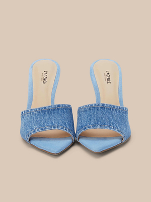 The Lolita Denim Open-Toe Mule features a denim upper, wide straps, and stiletto heels. The branded Lacieve insole adds a touch of style. Shown against a light beige background.
