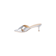 Aveline Kitten-Heel Sandal in silver metallic leather showcases a low kitten heel, open toe, and wide crisscross straps, displayed on a white background.