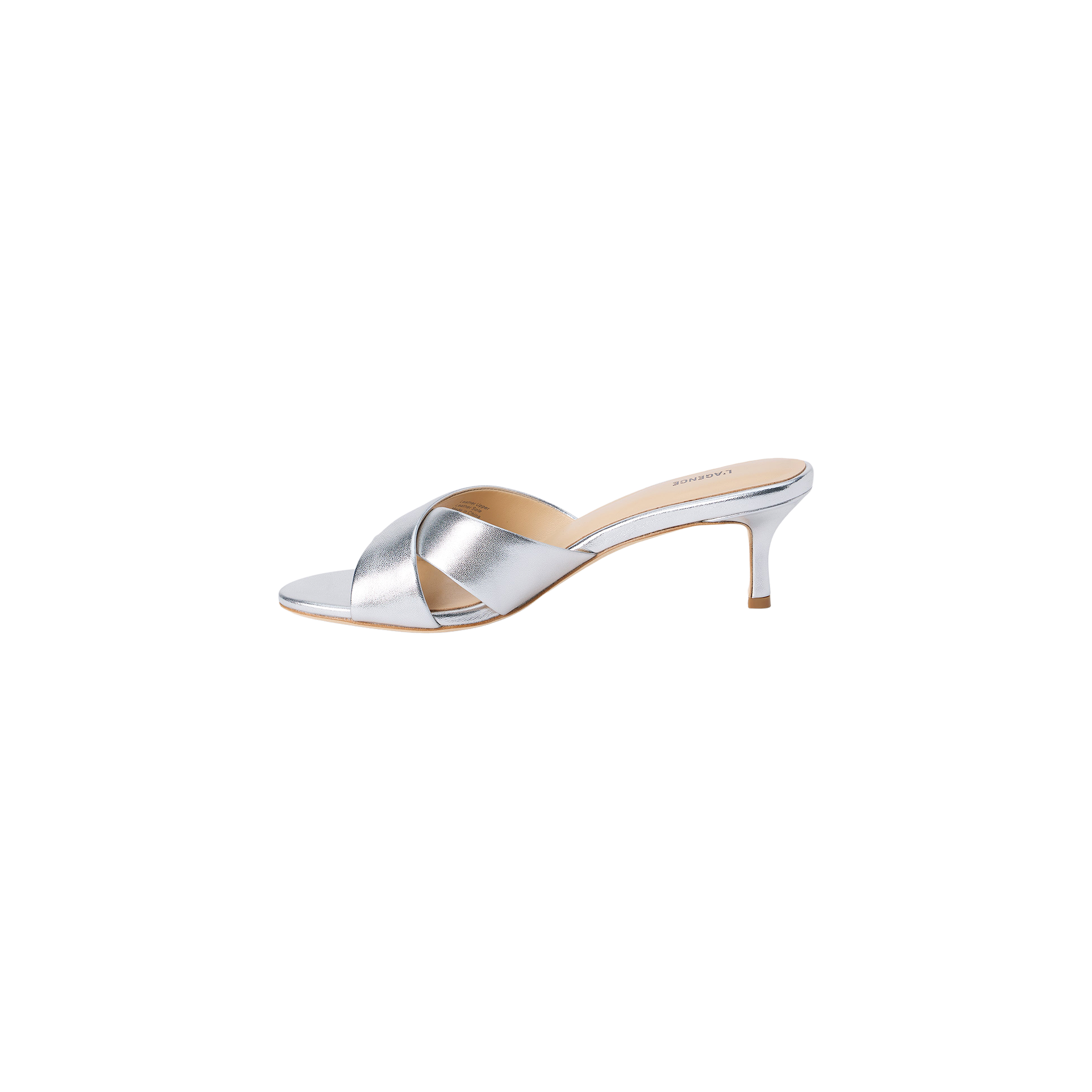 Aveline Kitten-Heel Sandal in silver metallic leather showcases a low kitten heel, open toe, and wide crisscross straps, displayed on a white background.