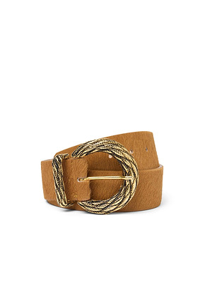 The Adelle Belt is a tan calf hair accessory with a gold-plated, textured oval buckle. Its soft, slightly fuzzy texture is on display as it’s rolled into a loose spiral against a white background.