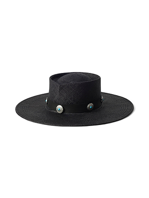The Adilah Wide-Brim Fedora is a handcrafted black hat from LA featuring a flat crown, black band, and turquoise and silver conchos spaced evenly around the band.