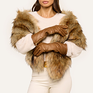 Model wearing luxury Carmen Gloves, styled with a faux fur jacket, cream sweater, and cream pants. Her head is partially out of frame as she poses with arms crossed against a light background.