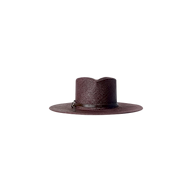 The Estella Fedora is a wide-brimmed straw hat in dark brown espresso, featuring a flat crown and a thin leather band, showcased against a plain white background.