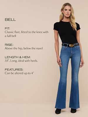 A woman stands against a beige background wearing a black t-shirt, blue bell-bottom jeans with a belt, and black shoes. Text describes the jeans fit, rise, length, and features.