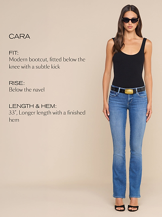 A woman in sunglasses, black tank top, and blue bootcut jeans stands against a beige background. Text describes the jeans fit, rise, and hem details.