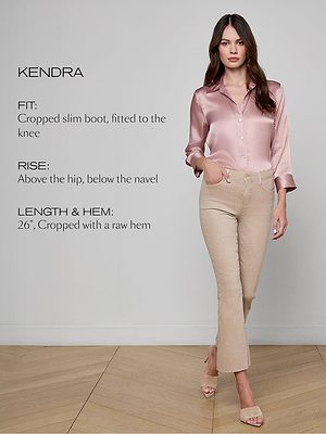 Woman wearing a pink satin shirt and beige pants with text describing the fit, rise, and length of the pants.