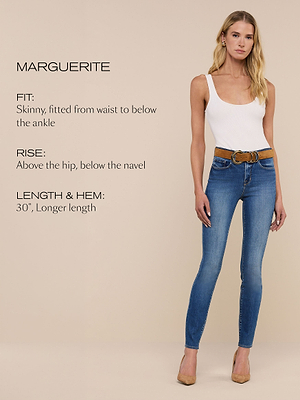 A woman wearing a white tank top and blue skinny jeans stands against a beige background. Text describes the jeans as Marguerite with a skinny fit, high rise, and a 30-inch longer length.