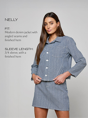 Woman wearing a blue checkered denim jacket with text describing the fit and sleeve length.