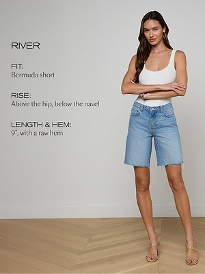 Woman wearing light blue denim shorts with product specifications on a plain background