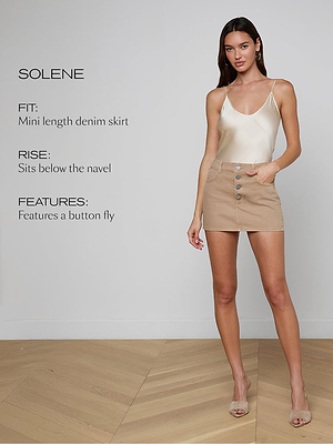 Woman wearing a beige denim skirt with button fly on a plain background, featuring product details.