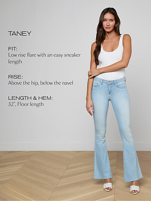 A woman stands on a wooden floor wearing light blue, low-rise flare jeans and a white tank top. Text beside her describes the jeans fit, rise, and length. She poses with one arm crossed and the other relaxed.