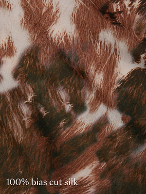 Close-up of brown and white patterned fabric with a fuzzy, organic texture. The text in the bottom left corner reads 100% bias cut silk.
