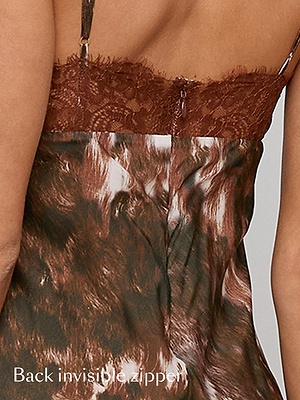 Close-up of a woman’s back wearing a dress with brown lace trim and a patterned fabric. The dress features an invisible zipper along the back. Text at the bottom reads, Back invisible zipper.