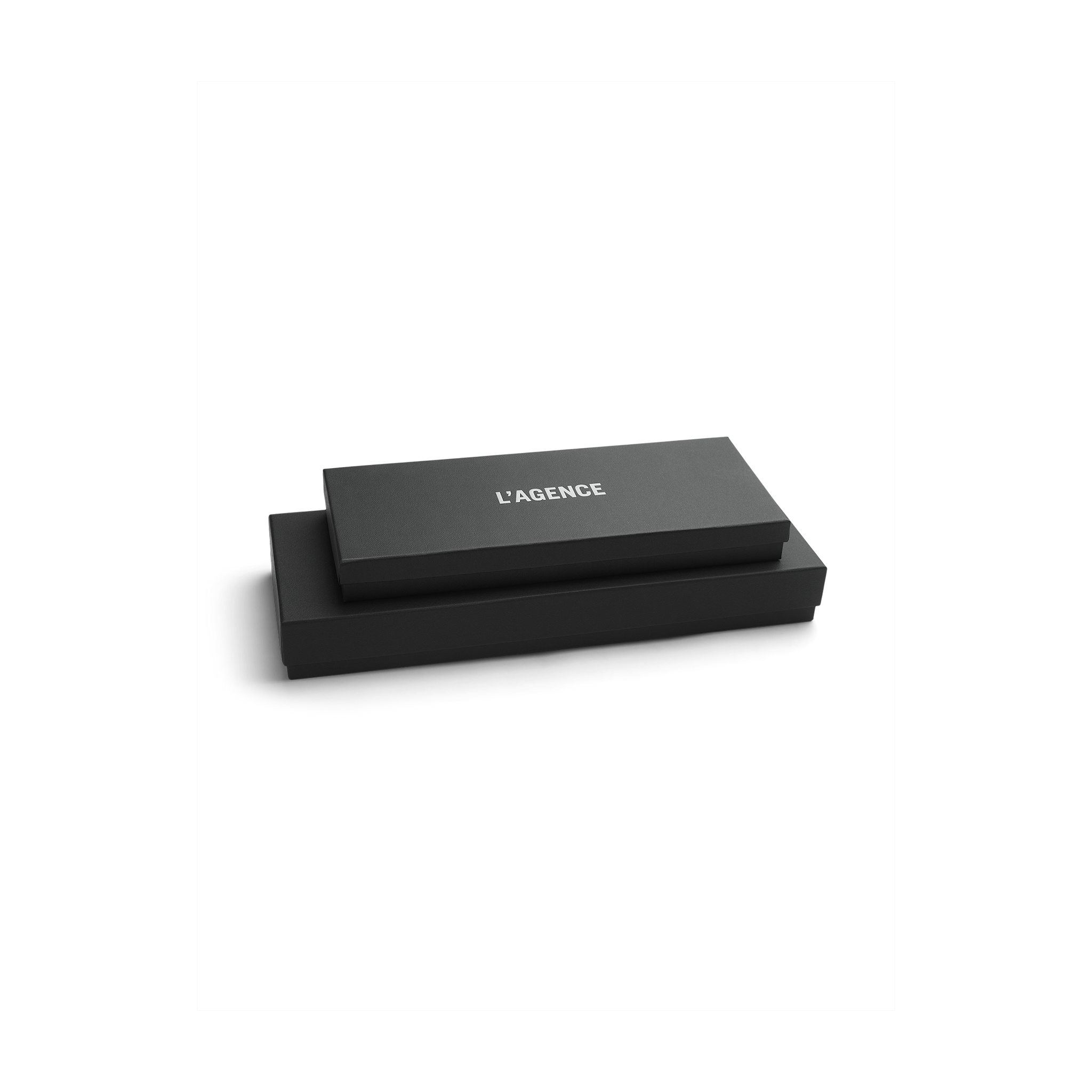 Two sleek black rectangular boxes are stacked, with the top box labeled LAGENCE in white, all set against a plain white background—evoking the refined elegance of Tempo Mittens by L’AGENCE.