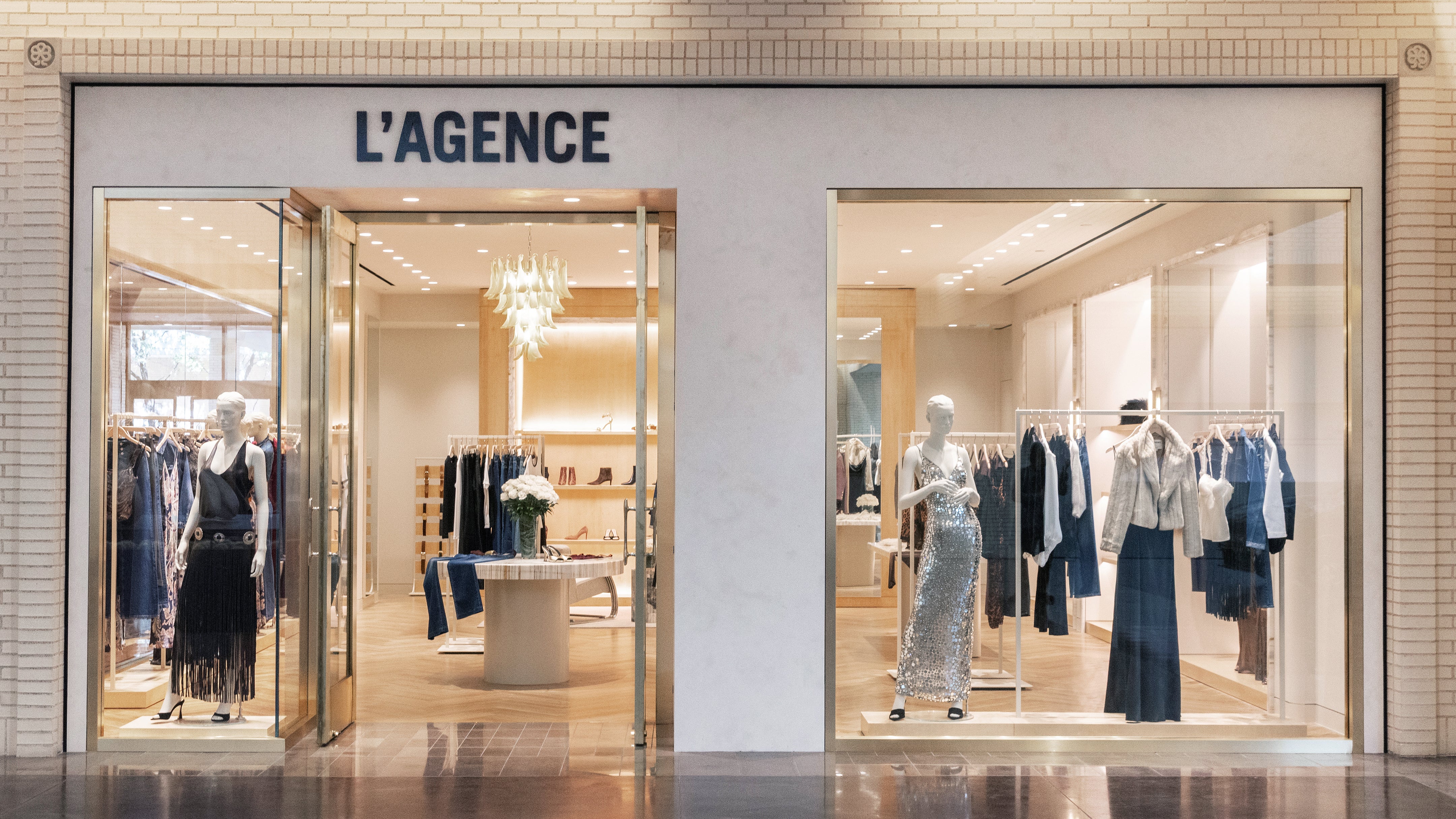 The LAGENCE clothing boutique storefront features mannequins in the windows displaying elegant evening wear.