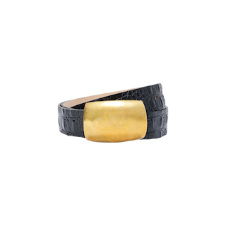 The Milou Belt—a handcrafted black, croc-embossed accessory from LA featuring a large, rectangular gold buckle—is displayed against a plain white background.