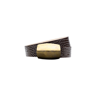 The Milou Belt, featuring brown croc-embossed leather and a large rectangular brass buckle, is coiled on a plain white background.