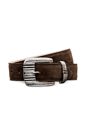 The Aya Suede Belt by L'AGENCE is a brown suede belt handcrafted in LA, featuring a large ornate silver-plated buckle and matching chevron-engraved belt loop, shown against a white background.