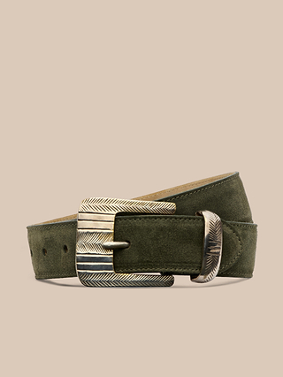 The Aya Suede Belt in olive green, handcrafted in LA, features a textured silver buckle and loop with a chevron pattern detail, and is displayed on a neutral beige background.