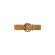 The Adelle Belt is a tan, handcrafted leather belt with a pointed tip and a round, gold-plated buckle featuring a twisted design, showcased against a plain white background.