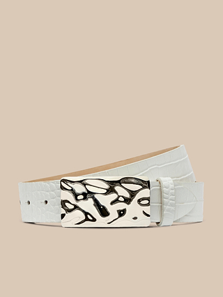 Chara Leather Belt in white croc-embossed leather, featuring a shiny, abstract silver-plated buckle, handcrafted in LA and shown coiled on a beige background.