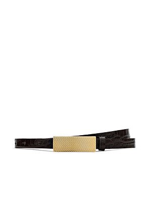 The Elyse Croc-Embossed Leather Belt by L'AGENCE is crafted in LA from dark brown calfskin with a croc pattern and finished with a rectangular 24k gold-plated buckle, shown coiled on a white background.