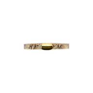 The Milou Belt, a thin snake-embossed accessory with a shiny gold rectangular buckle, is displayed against a plain white background.