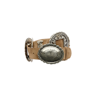 Austin Suede Belt in handcrafted tan suede, coiled with ornate, silver-toned metal accents and an oval buckle.