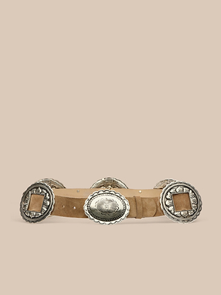 The Austin Suede Belt, handcrafted in LA, features large, ornate silver conchos with engraved designs on tan suede and is displayed against a plain beige background.
