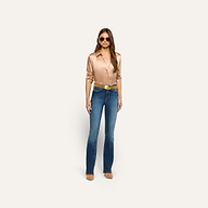 A person wearing a tan button-down shirt, blue flare jeans, a cognac brown Montell Suede Belt with a gold buckle, and sunglasses.