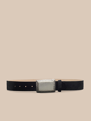 Introducing the Solera Belt: a handcrafted black calf hair accessory from LA, showcased against a beige background. It features a bold rectangular silver buckle adorned with intricate engraved detailing.