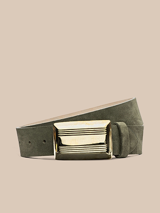 The Cebo Belt, crafted by hand in LA from premium Italian suede in green, showcases a statement large rectangular gold buckle and is set against a simple beige background.
