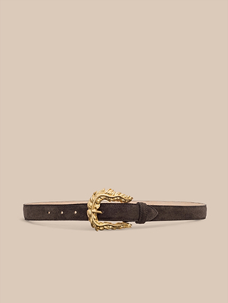 The Sedaris Suede Belt, handcrafted in LA from brown suede, features a decorative gold buckle with a leaf-inspired design and is displayed against a beige background.