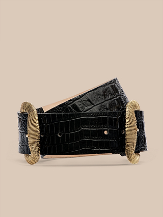 The Rooney Leather Belt, crafted from luxurious Italian leather in a wide black crocodile print, features an ornate gold-plated buckle and matching gold tip, elegantly displayed against a plain beige background.