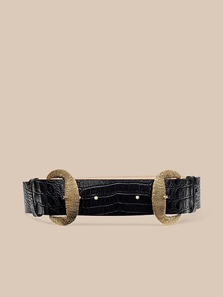 The Rooney Leather Belt is a wide black crocodile print accessory, expertly crafted from luxurious Italian leather and distinguished by two large gold-plated textured oval buckles, showcased against a plain beige background.