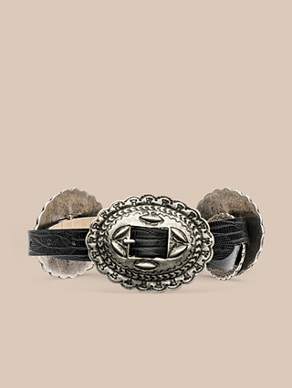 The Rocha Leather Belt is a black Italian leather belt handcrafted in LA, featuring an ornate oval silver buckle with engraved patterns, displayed against a plain beige background.