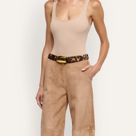 Milou Belt in leopard print Italian calf hair with a large, polished gold-tone rectangular buckle, worn with tan trousers and a beige tank top.