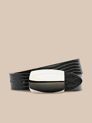 The Milou Belt, featuring black lizard-embossed leather and a glossy rectangular sterling silver-plated buckle, is coiled in a loop and displayed against a plain beige background.