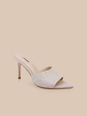 The Lolita Linen Open-Toe Mule features a linen stiletto heel and chain embroidery lace in light beige, shown on a plain beige background.