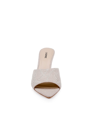 Front view of the Lolita Linen Open-Toe Mule in beige, featuring a wide embroidered linen strap, open toe, and flat sole, displayed against a white background.