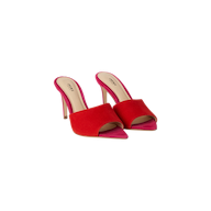 A pair of Lolita Suede Open-Toe Mules with stiletto heels, showcasing pink insoles and heels, and vibrant red open-toe suede uppers, set against a white background.
