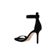 The Gisele Suede Sandal, a black ankle-strap design featuring a high heel and open toe, is displayed in a side profile against a plain white background.