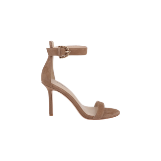 The Gisele Suede Sandal, in coffee brown, features a thin ankle strap with a gold buckle, an open toe design, and a sleek stiletto heel, elegantly showcased against a plain white background.