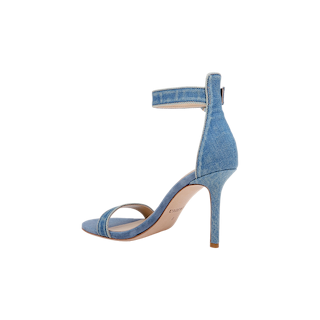 The Gisele Denim Sandal is a blue high-heel sandal featuring an ankle strap, open toe, and a back zipper, displayed against a plain white background.