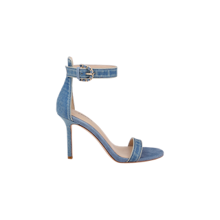 The Gisele Denim Sandal is a blue denim ankle-strap sandal with a high heel, buckle closure, and open toe design, displayed on a plain white background.