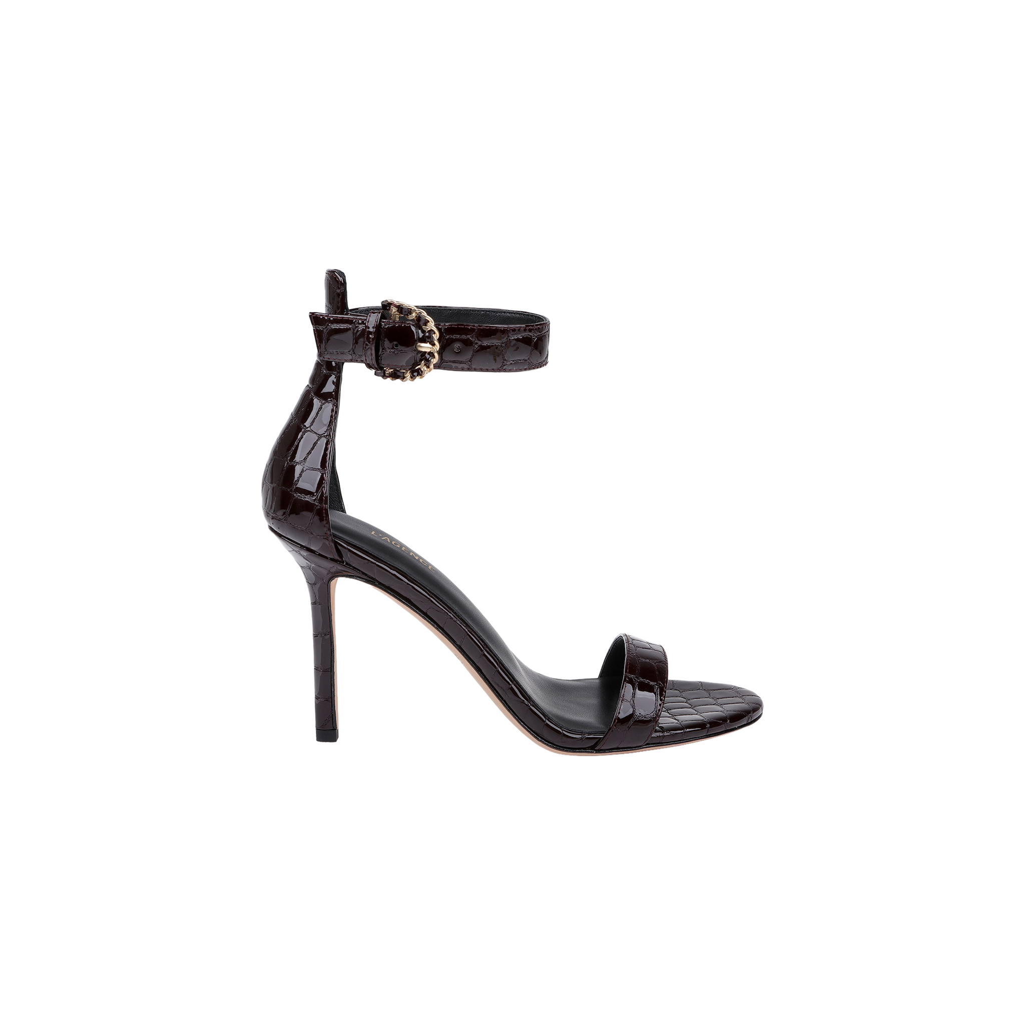 The Gisele Leather Sandal is a black, high-heeled shoe crafted from crocodile-embossed leather, featuring an ankle strap with a decorative buckle and a single toe strap, displayed in profile on a white background.