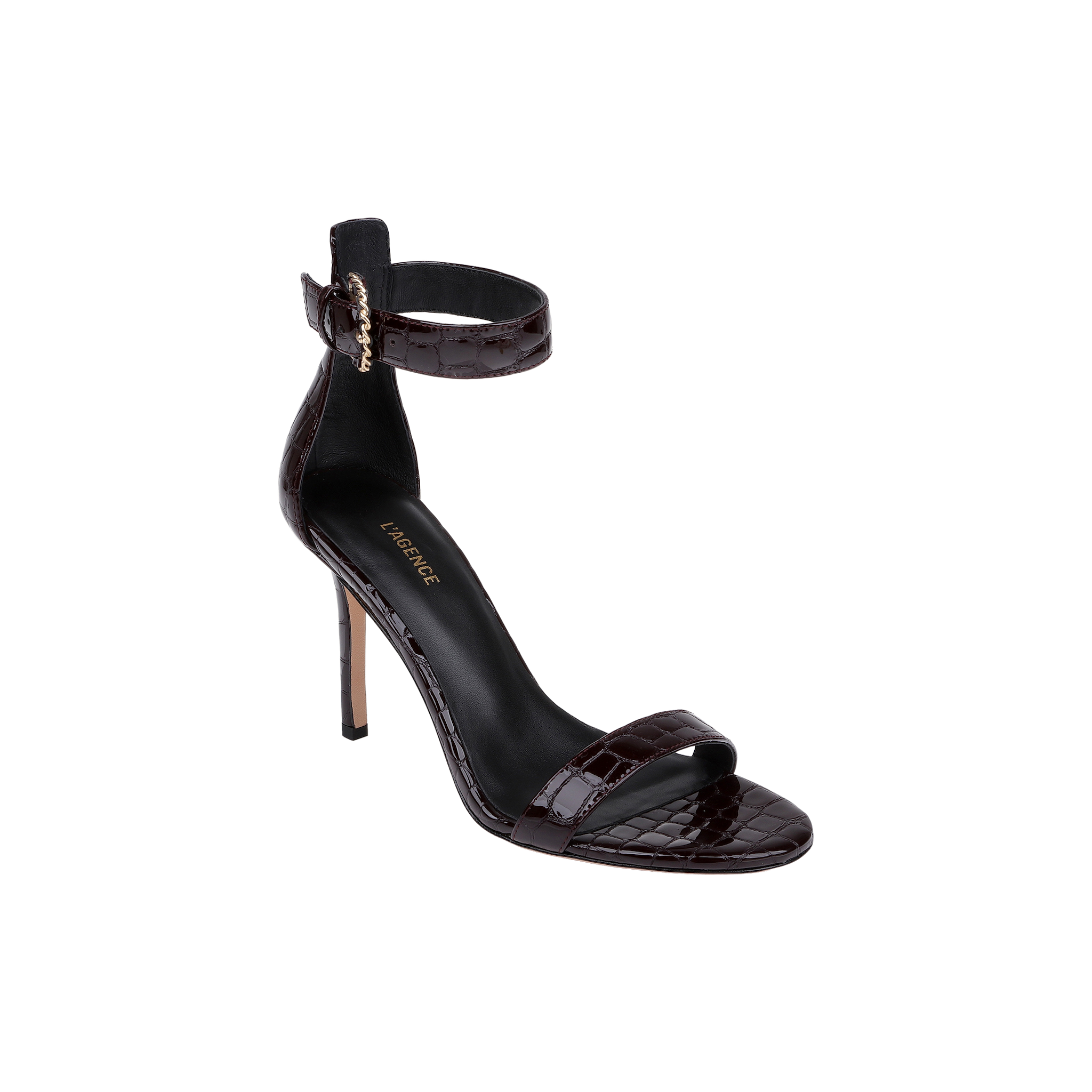 The Gisele Leather Sandal is a black, high-heeled ankle-strap sandal featuring a gold buckle, open toe, and crocodile embossed leather finish, displayed on a white background.