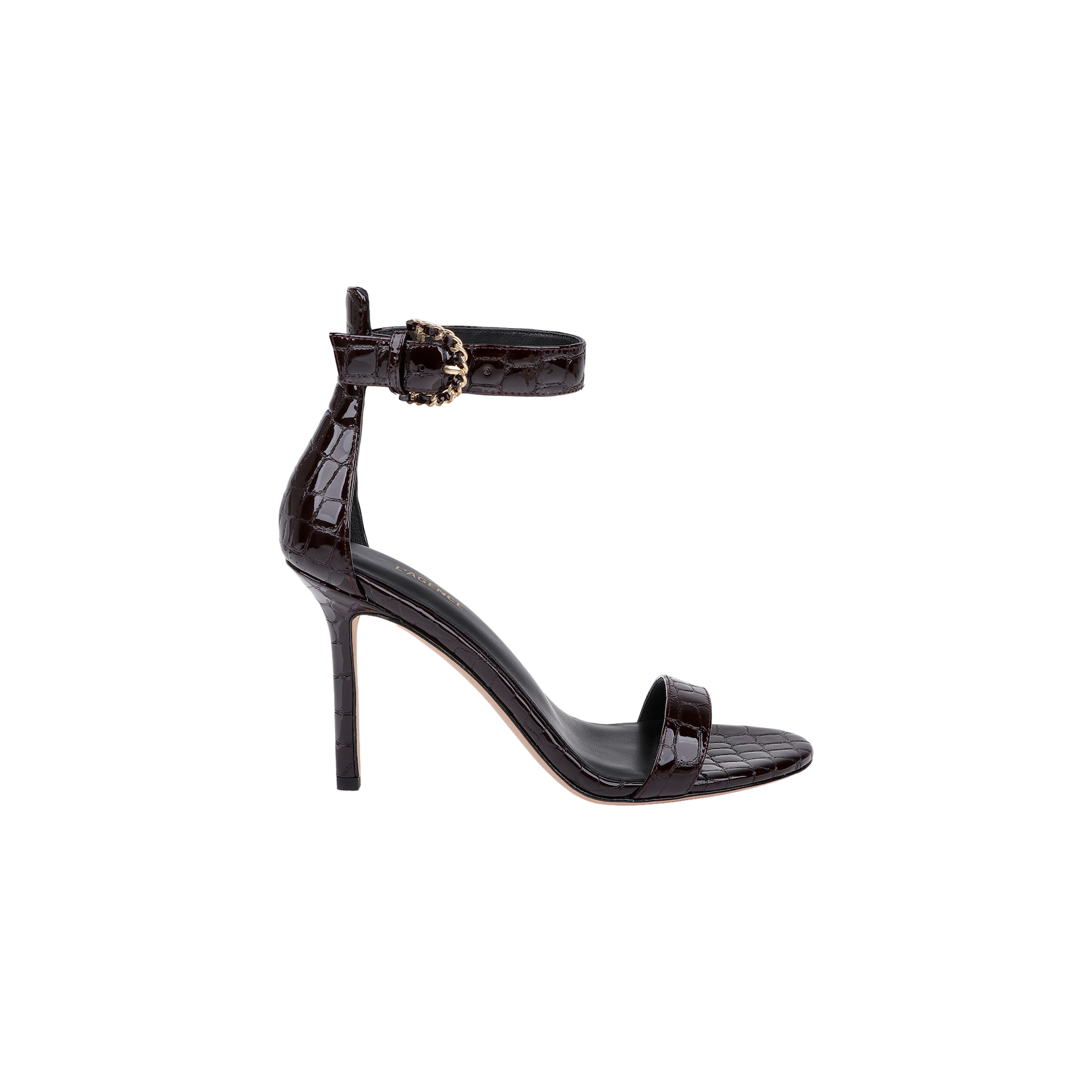 The Gisele Leather Sandal is a black high-heeled ankle-strap sandal made from crocodile embossed leather, showcasing a decorative gold buckle at the ankle and a single front strap. It is displayed on a plain white background.
