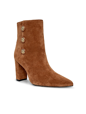 The Theodora Block-Heel Bootie by L’AGENCE is a buckskin suede pointed-toe style with a chunky block heel and three gold buttons accenting the outer side.